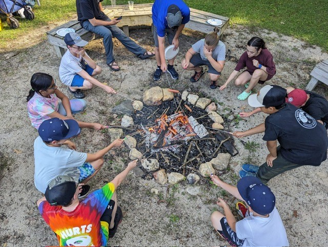 Summer Camp-Nature Quest cooking hotdogs