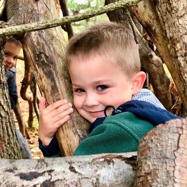 Child hugging tree