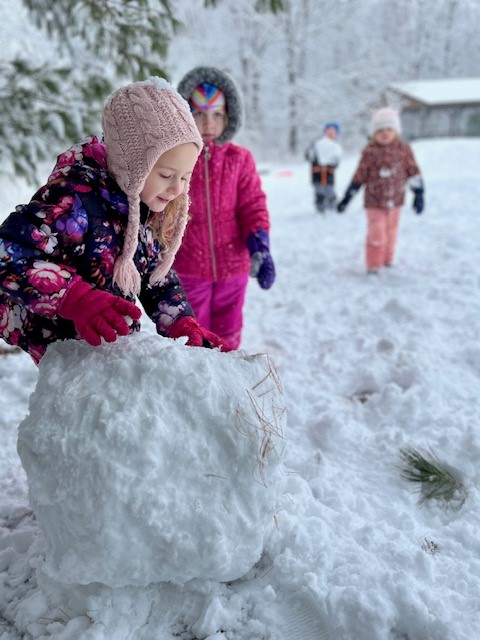 Two girls with large snowball